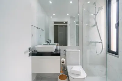 a white bathroom with a toilet and a sink at Linda Vista Apartment by Amazing Madeira in Funchal