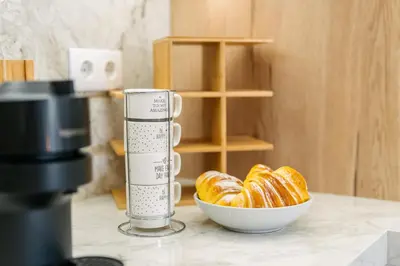 a cup of coffee next to a bowl of croissants at Linda Vista Apartment by Amazing Madeira in Funchal