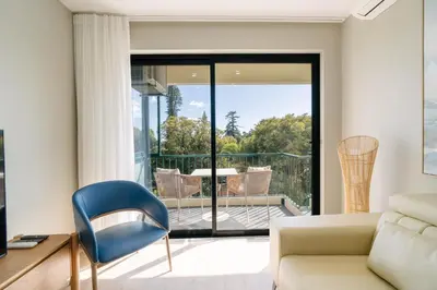 a living room with a couch and a chair at Linda Vista Apartment by Amazing Madeira in Funchal