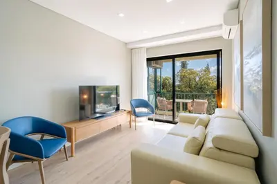 a living room with a couch and a tv at Linda Vista Apartment by Amazing Madeira in Funchal