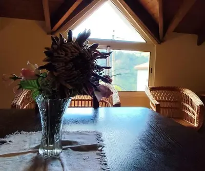 a long wooden table with black chairs around it at IlhaMontanha - Serras da Ilha in Santana