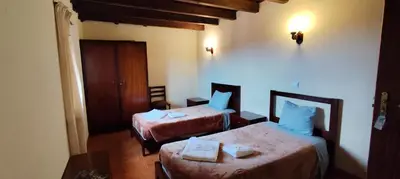 a living room with a table and chairs at IlhaMontanha - Serras da Ilha in Santana