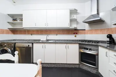 a living room with a couch and a tv at GuestReady - Charming Apartment with Ocean Views in Caniço