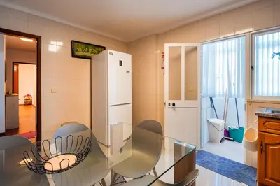 a kitchen with a glass table and a refrigerator at GuestReady - Machico Apartment with Balcony in Machico
