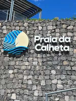 a sign for a patio cal retailer on a stone wall at Estrela House III, Calheta, Madeira in Calheta