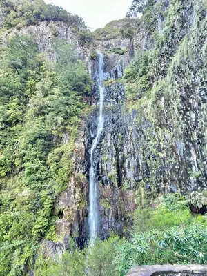 a waterfall on the side of a mountain at Estrela House III, Calheta, Madeira in Calheta