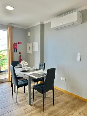 a dining room with a table and chairs at Estrela House III, Calheta, Madeira in Calheta