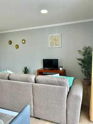 a living room with two couches and a tv at Estrela House III, Calheta, Madeira in Calheta