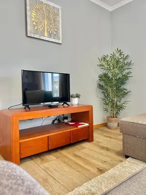 a living room with a flat screen tv on a entertainment center at Estrela House III, Calheta, Madeira in Calheta