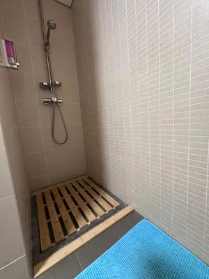 a shower stall with a wooden frame in a bathroom at Heart of Madeira SEASIDE in Funchal