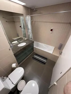 a bathroom with a toilet and a sink and a tub at Heart of Madeira SEASIDE in Funchal