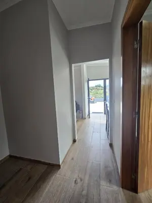 an empty room with a hallway with wood floors at Casa Rosa in Porto da Cruz
