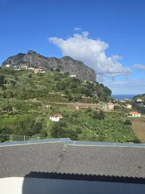 a view of a mountain with houses on a hill at Casa Rosa in Porto da Cruz