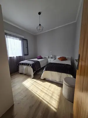 a bedroom with two beds and a window at Casa Rosa in Porto da Cruz