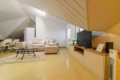 a living room with a couch and a table at Banda Além Apartment by Mth in Tábua