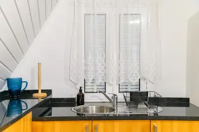 a kitchen with a sink and a window at Banda Além Apartment by Mth in Tábua