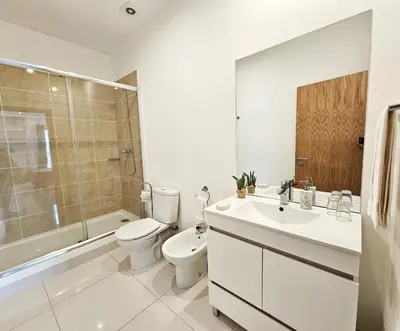 a bathroom with a toilet and a sink and a shower at Anadia Atrium in Funchal