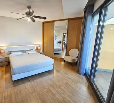 a bedroom with a white bed and a large window at Anadia Atrium in Funchal