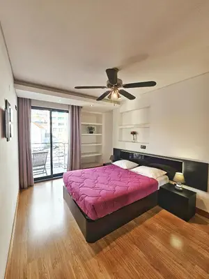 a bedroom with a pink bed and a ceiling fan at Anadia Atrium in Funchal