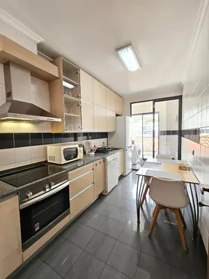 a large kitchen with a table and a dining room at Anadia Atrium in Funchal