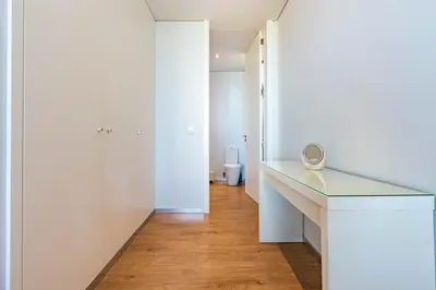 a white bathroom with a desk and a mirror at Villa Pinheira III heated pool in Calheta