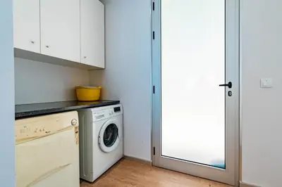 a laundry room with a washer and dryer at Villa Pinheira III heated pool in Calheta
