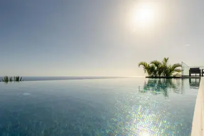 a swimming pool with the ocean in the background at Villa CLIFF HEAVEN HOUSE in Calheta