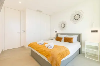 a bedroom with a bed with two towels on it at Villa CLIFF HEAVEN HOUSE in Calheta