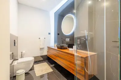 a bathroom with a sink and a toilet and a mirror at Villa CLIFF HEAVEN HOUSE in Calheta