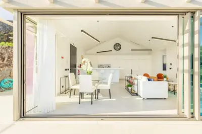 a kitchen and dining room with a large window at Villa CLIFF HEAVEN HOUSE in Calheta