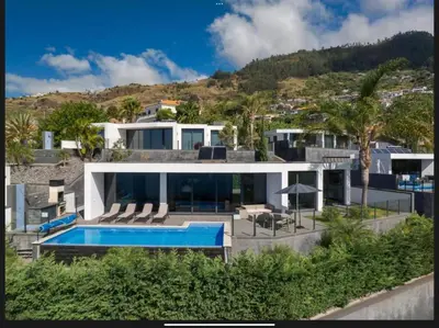 an aerial view of a house with a swimming pool at Villa Rubydom by Turin in Arco da Calheta