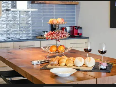 a table with a bunch of bread and glasses of wine at Villa Rubydom by Turin in Arco da Calheta