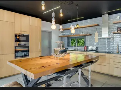 a large kitchen with a wooden table in it at Villa Rubydom by Turin in Arco da Calheta