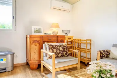 a living room with a chair and a table at O Miminho, a Home in Madeira in São Jorge