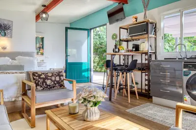 a kitchen and living room with a couch and a table at O Miminho, a Home in Madeira in São Jorge