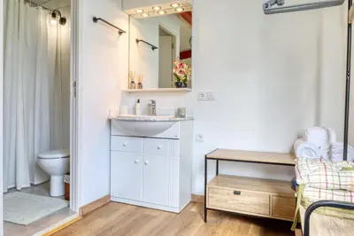 a bathroom with a sink and a toilet and a mirror at O Miminho, a Home in Madeira in São Jorge
