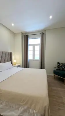 a bedroom with a large bed and a window at In City - Funchal Heart with Rooftop in Funchal