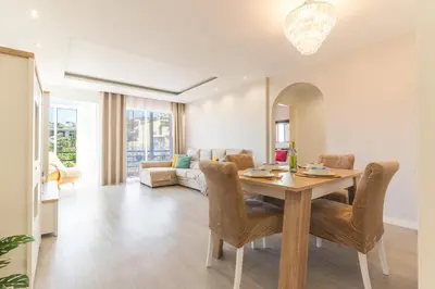 a living room with a wooden table and chairs at Sol Garajau Apartment by Atlantic Holiday in Santa Cruz