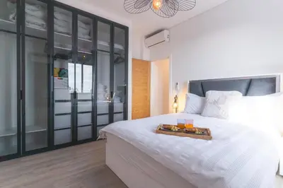 a bedroom with a bed with a tray of food on it at Midnight House by Atlantic Holiday in Câmara de Lobos
