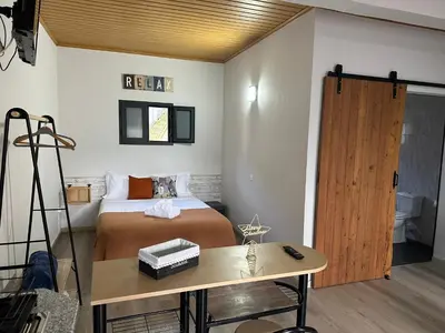 a bedroom with a bed and a wooden door at Cantinho S & F in Machico