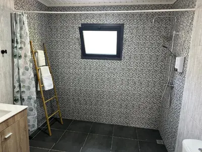 a bathroom with a shower and a window at Cantinho S & F in Machico