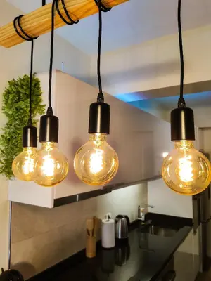 four lights hanging from the ceiling in a kitchen at Vitoria's Vale in Funchal