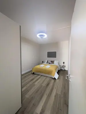 a bedroom with a bed with a yellow blanket at Vitoria's Vale in Funchal