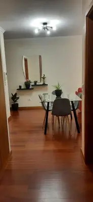 a kitchen with wooden cabinets and a table and chairs at Paradise Valley Ponta do Sol in Ponta do Sol