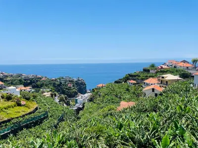 a village on a hill with the ocean in the background at Sunny Escape - Ponta do Sol - Vila Silva Downstairs in Ponta do Sol