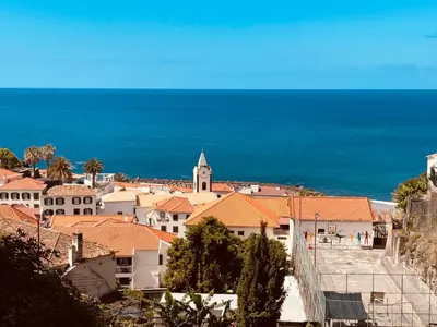 a view of a town with the ocean in the background at Sunny Escape - Ponta do Sol - Vila Silva Downstairs in Ponta do Sol