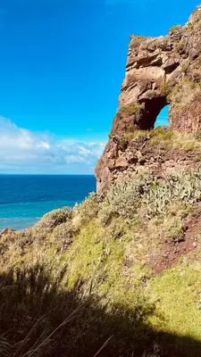 a cave in the side of a cliff next to the ocean at Sunny Escape - Ponta do Sol - Vila Silva Downstairs in Ponta do Sol