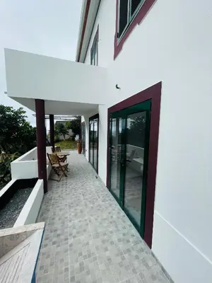 an external view of a white house with a door at Sunny Escape - Ponta do Sol - Vila Silva Downstairs in Ponta do Sol