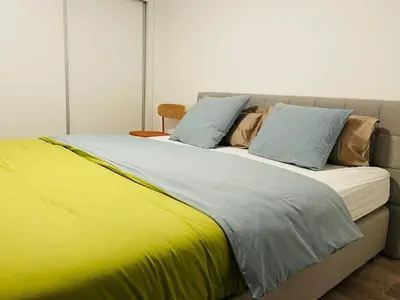 a large bed with yellow and blue pillows on it at Sunny Escape - Ponta do Sol - Vila Silva Downstairs in Ponta do Sol