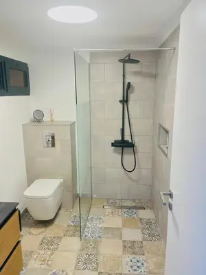 a bathroom with a toilet and a shower stall at Sunny Escape - Ponta do Sol - Vila Silva Downstairs in Ponta do Sol
